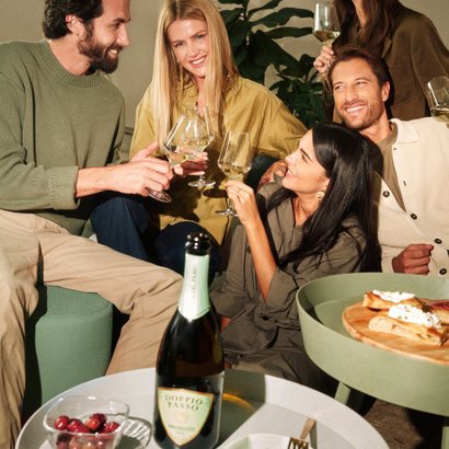 People toasting with Prosecco Doppio Passo in an elegant setting.